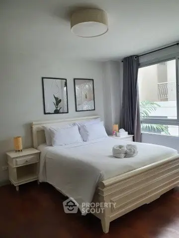 Cozy bedroom with elegant decor and large window for natural light