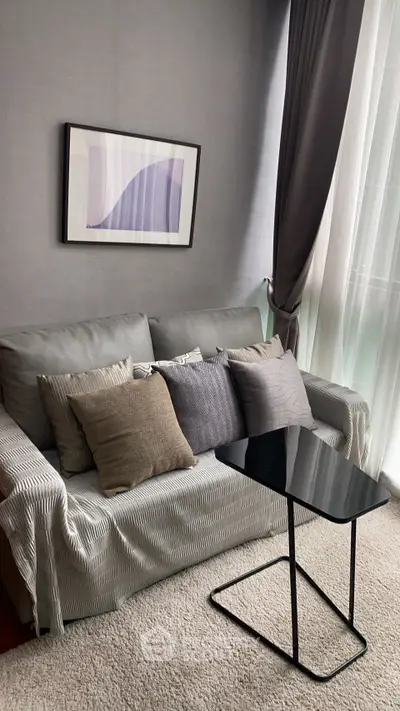 Cozy living room with modern sofa, stylish cushions, and elegant decor in a bright, inviting space.