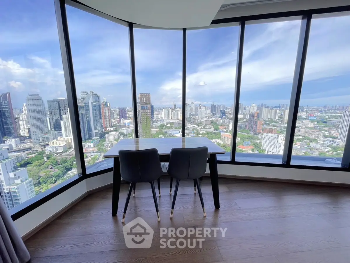 Stunning high-rise apartment with panoramic city views and elegant dining area.