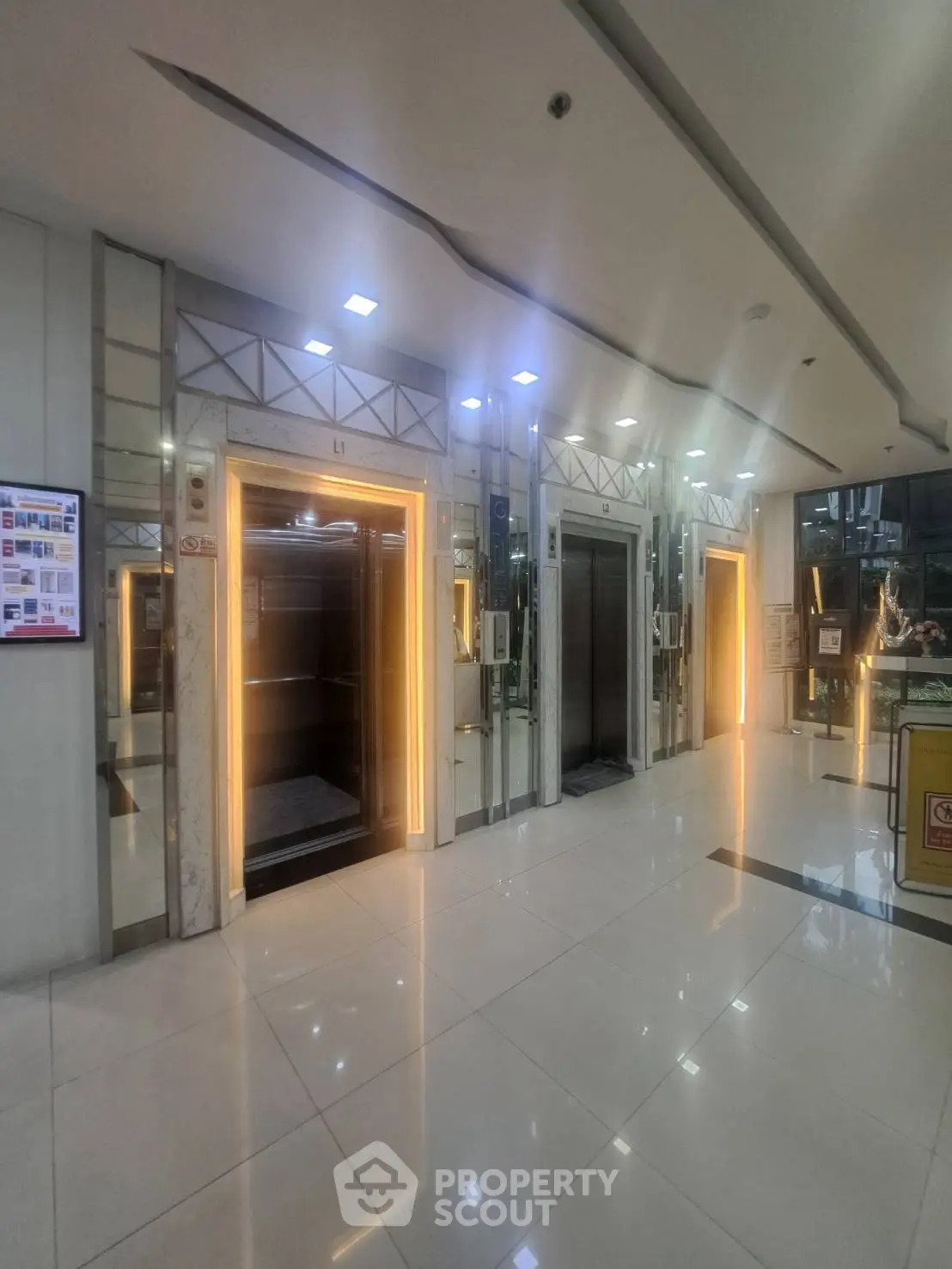 Modern building lobby with illuminated elevators and sleek design