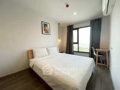 Modern bedroom with large window and minimalist decor in high-rise apartment