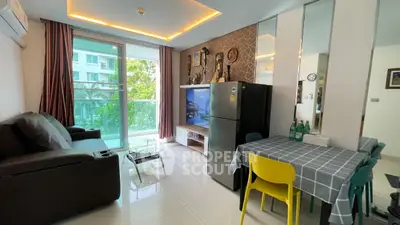 Modern living room with balcony, stylish decor, and dining area in a bright apartment.