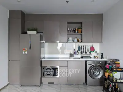 Modern kitchen with sleek cabinetry, integrated appliances, and stylish decor