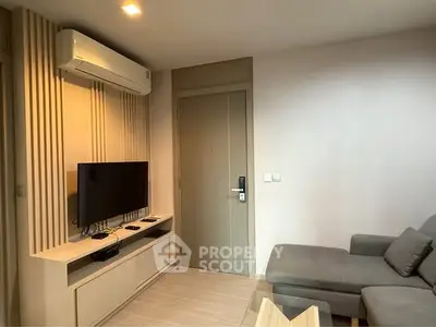 Modern living room with sleek design, featuring a wall-mounted TV and comfortable seating.