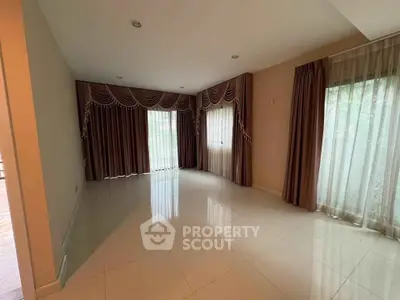 Spacious empty living room with elegant curtains and glossy tiled floor.