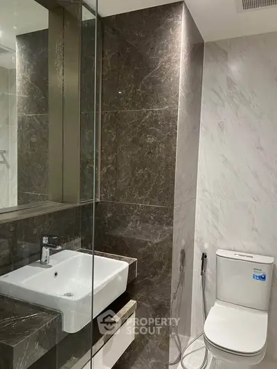 Modern bathroom with sleek marble tiles and contemporary fixtures