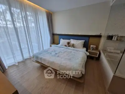 Modern bedroom with large window and cozy decor