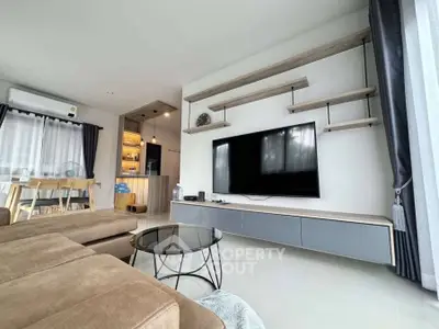 Modern living room with sleek TV setup and stylish shelving