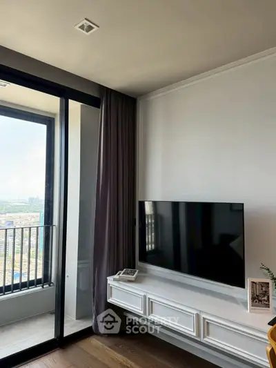 Modern living room with sleek TV setup and balcony view in luxury apartment