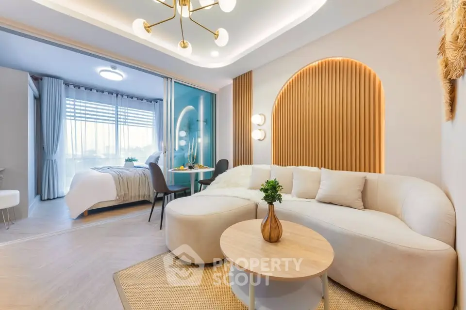 Luxurious open-plan living room with modern decor and cozy bedroom view