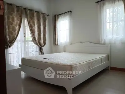 Spacious bedroom with elegant curtains and natural light