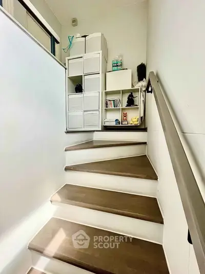 Stylish staircase with modern storage solutions in a bright home interior