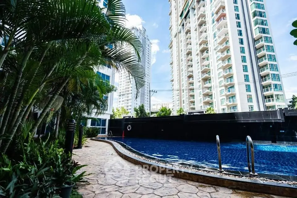 Luxurious residential complex with stunning pool and lush greenery