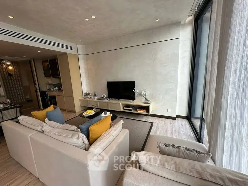 Modern living room with stylish decor and large windows for natural light