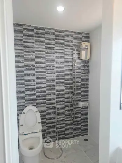 Modern bathroom with stylish gray tile wall and sleek fixtures