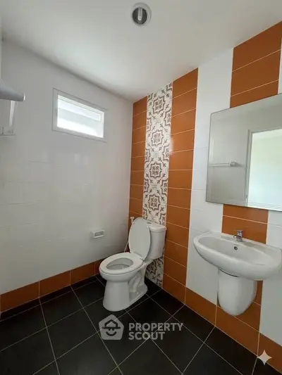 Modern bathroom with stylish tile accents and sleek fixtures in a contemporary home.