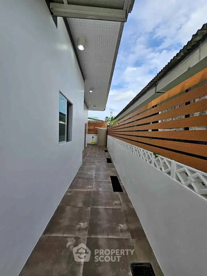 Modern exterior corridor with sleek design and stylish fencing