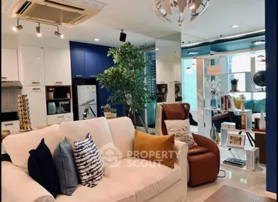 Stylish modern living room with cozy seating and elegant decor in a contemporary apartment.