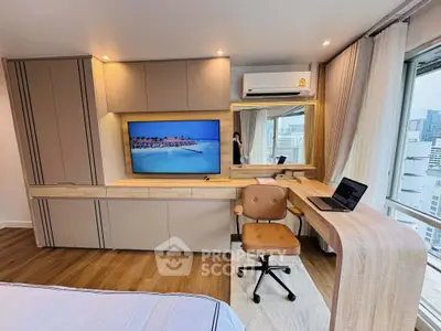Modern bedroom with built-in TV, desk, and city view, perfect for urban living.