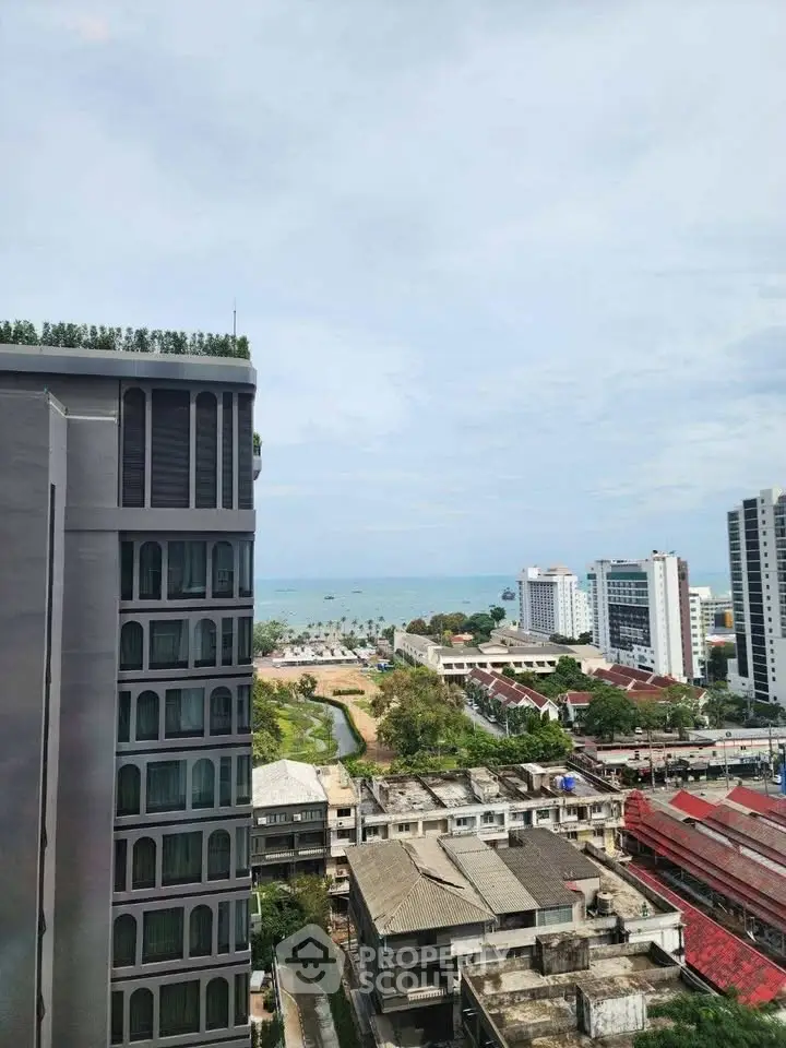Stunning high-rise view of cityscape and ocean horizon, perfect for urban living.