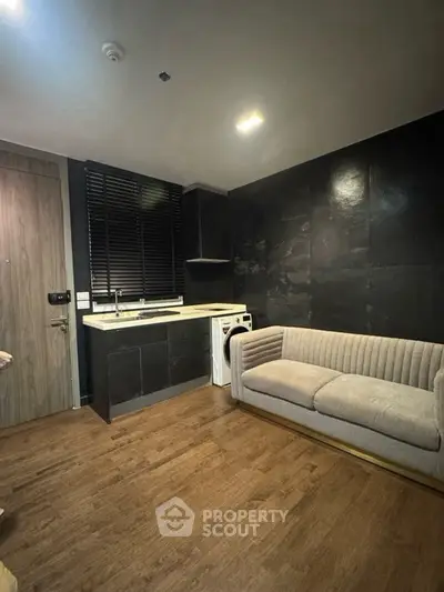 Modern compact living room with sleek kitchen and washing machine