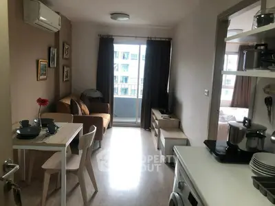 Cozy apartment living room with dining area and modern kitchen appliances.