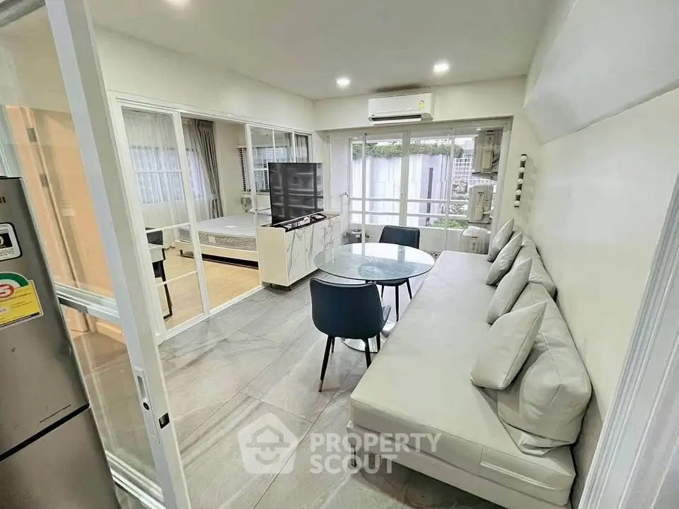 Modern living room with sleek furniture and open layout in a stylish apartment.