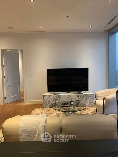 Luxurious living room with modern TV setup and elegant marble stand