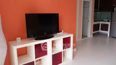 Modern living room with vibrant orange wall and sleek TV setup