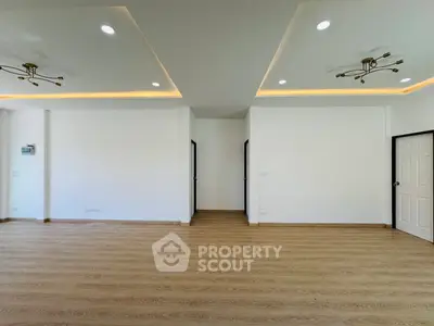 Spacious modern living room with elegant lighting and wooden flooring