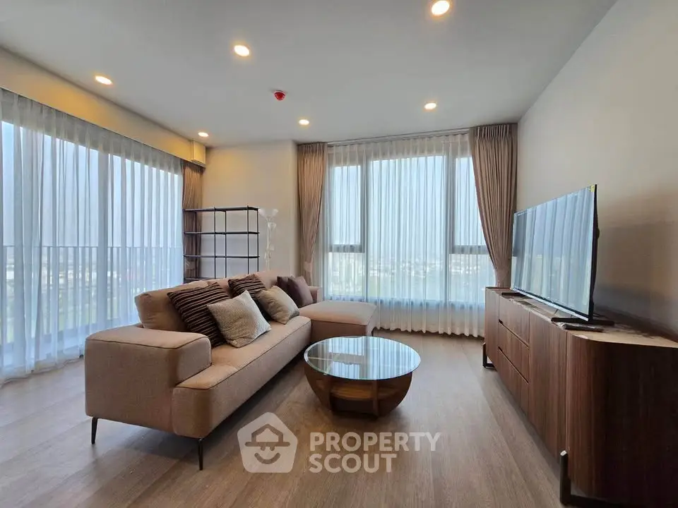 Spacious modern living room with large windows and stylish furniture