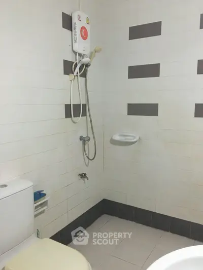 Compact bathroom with shower and toilet in modern apartment