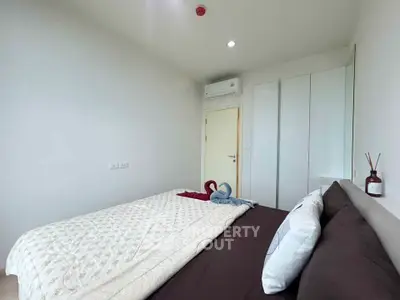 Cozy bedroom with modern decor and air conditioning in a stylish apartment.