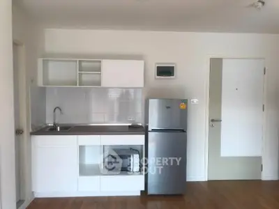 Modern compact kitchen with sleek appliances and minimalist design