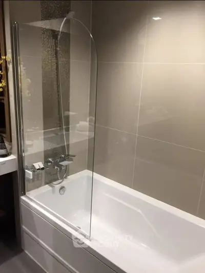 Modern bathroom with sleek bathtub and glass shower screen
