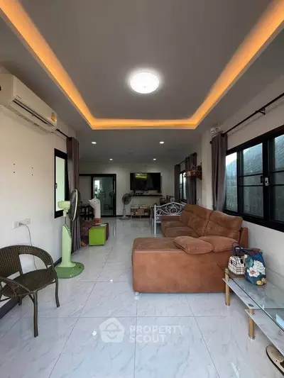 Spacious living room with modern lighting and cozy seating area