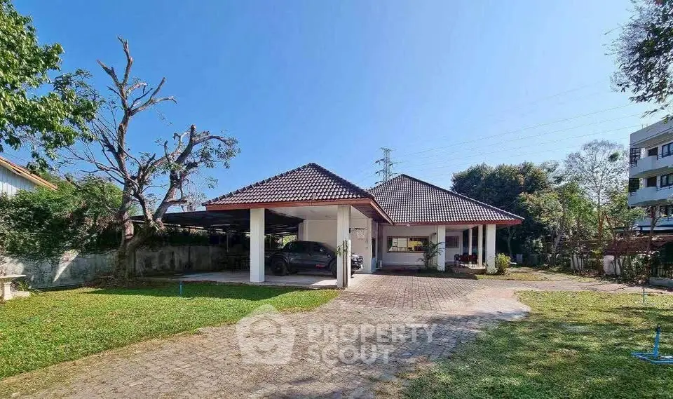 Charming single-story home with spacious driveway and lush garden.