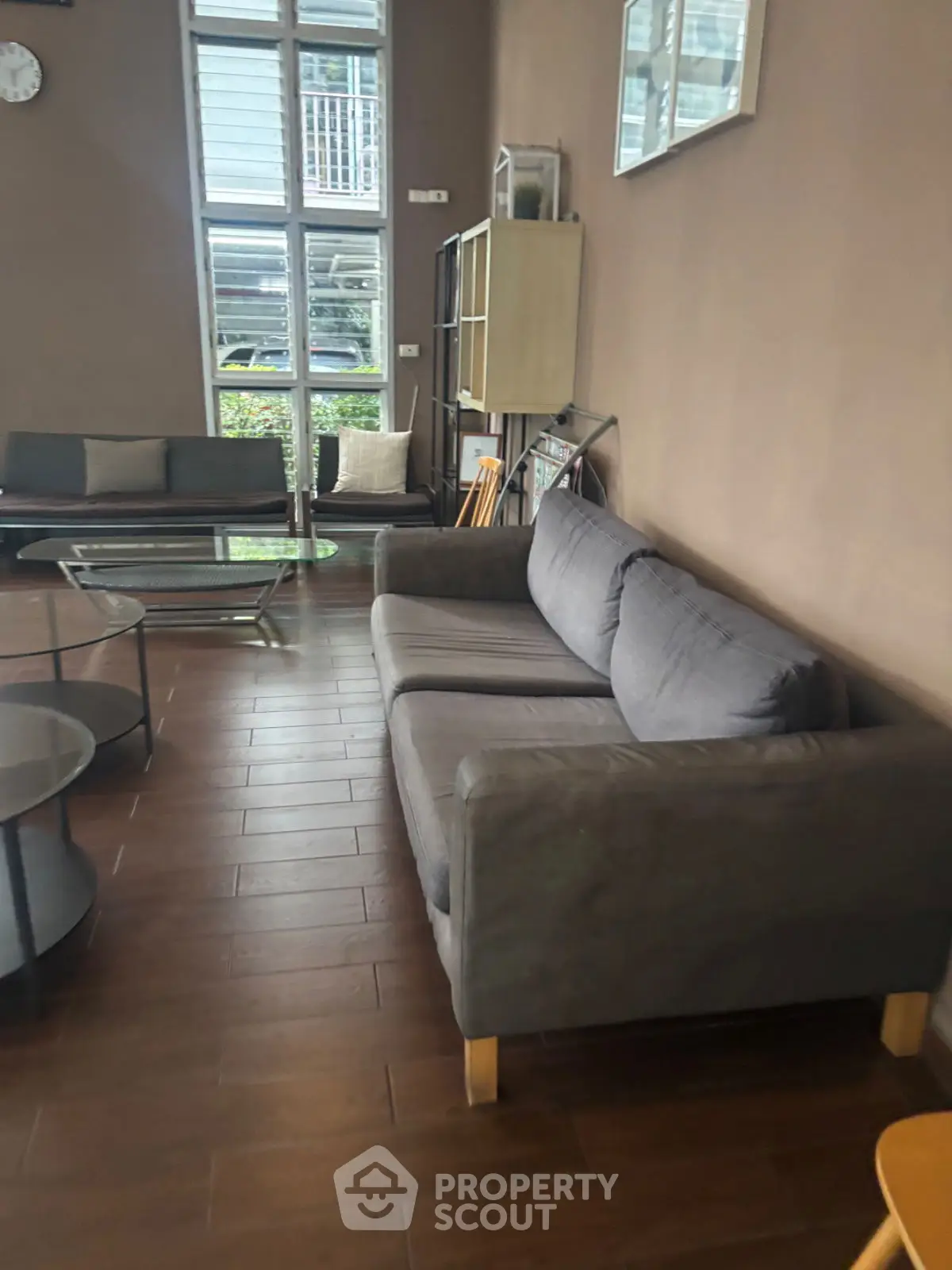 Spacious living room with modern furniture and large windows for natural light.