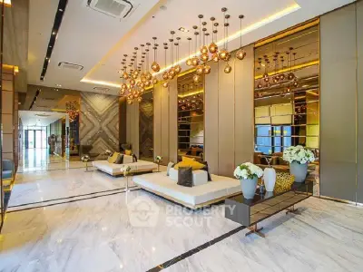 Luxurious modern lobby with elegant lighting and marble flooring in upscale building.