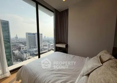 Luxurious bedroom with stunning city view from floor-to-ceiling windows