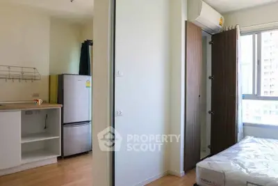 Modern apartment interior with compact kitchen and cozy bedroom