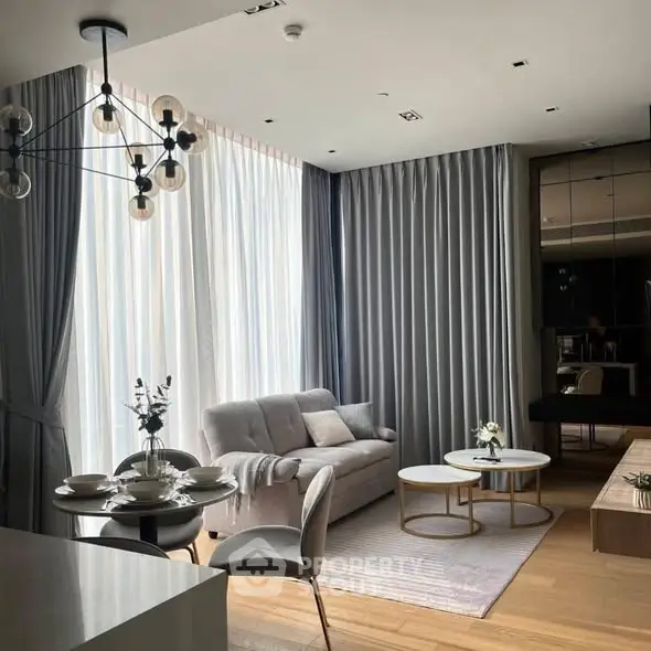 Elegant modern living room with stylish furniture and floor-to-ceiling windows.