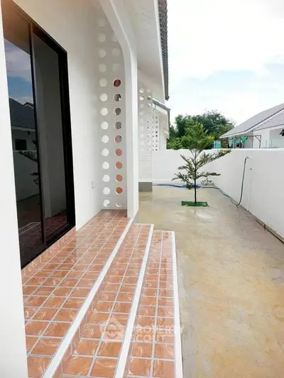Charming modern home exterior with stylish tiled steps and minimalist garden.