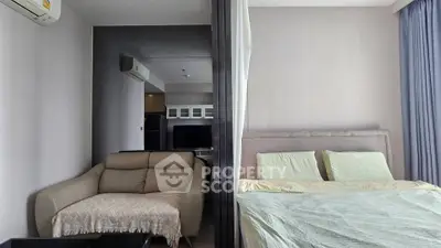 Modern studio apartment with cozy living area and comfortable bed