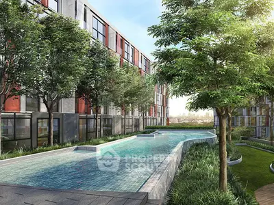 Luxurious modern apartment complex with stunning pool and lush greenery.