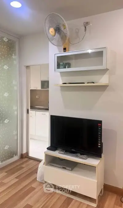 Modern living room with TV and stylish shelving in a cozy apartment
