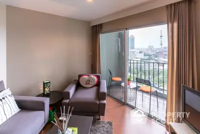 Inviting modern living room with plush seating and abundant natural light, leading to a cozy balcony with an urban view.