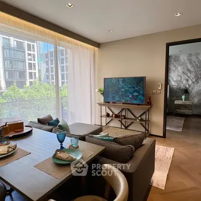 Modern living room with large windows and stylish decor in a high-rise apartment.