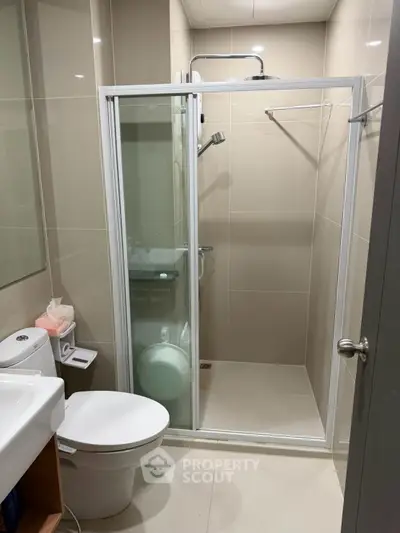 Modern bathroom with glass shower enclosure and sleek fixtures