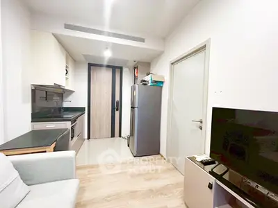 Modern compact apartment with sleek kitchen and cozy living area